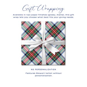 May include: Gift wrapping with a Stewart tartan pattern. The gift wrap is white with a plaid design in red, green, and blue, tied with a white ribbon. The text says "Gift Wrapping" and "No Personalization".