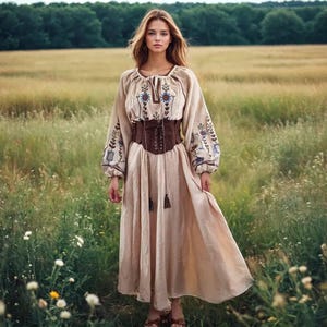 May include: A beige long-sleeved dress featuring blue and green floral embroidery on the chest and sleeves. The garment includes a dark brown corset-style waist belt with a lace-up front and long dangling ties, paired with a flowing skirt.