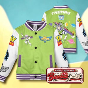 May include: A lime green and white baseball jacket featuring Buzz Lightyear graphics, Toy Story logos, and purple striped trim. The back displays the name Thomas, a Space Rangers emblem, and space-themed illustrations. The front has a button closure.