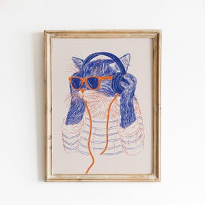 May include: A framed art print featuring a line-art illustration of a cat wearing bright orange sunglasses and blue headphones. The cat is depicted in blue ink, wearing a striped shirt, with an orange cord extending from the headphones downward.