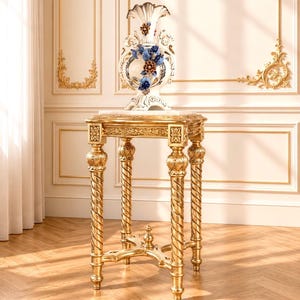 May include: A tall, ornate gold-finished pedestal table with four twisted legs and a square top, supporting a white ceramic vase decorated with blue and gold floral accents, featuring a scalloped rim and intricate relief detailing on the body.