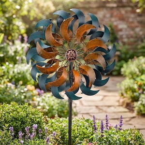 May include: A dual-toned metal wind spinner featuring two concentric circular arrays of curved blades. The inner blades have a metallic copper finish, while the outer blades are finished in a deep teal. A central floral-shaped hub connects the blades.
