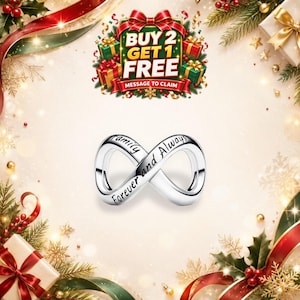 May include: A silver-toned infinity charm featuring the engraved text Family and Forever and Always. The charm is centered against a festive holiday background with gift boxes, pine branches, and a sign stating BUY 2 GET 1 FREE.