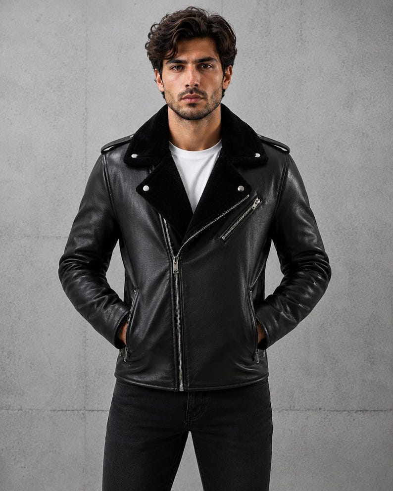 May include: A black leather jacket featuring a wide collar lined with black faux fur, a diagonal silver-tone metal zipper closure, two zippered side pockets, one zippered chest pocket, and shoulder epaulets, worn over a plain white t-shirt.