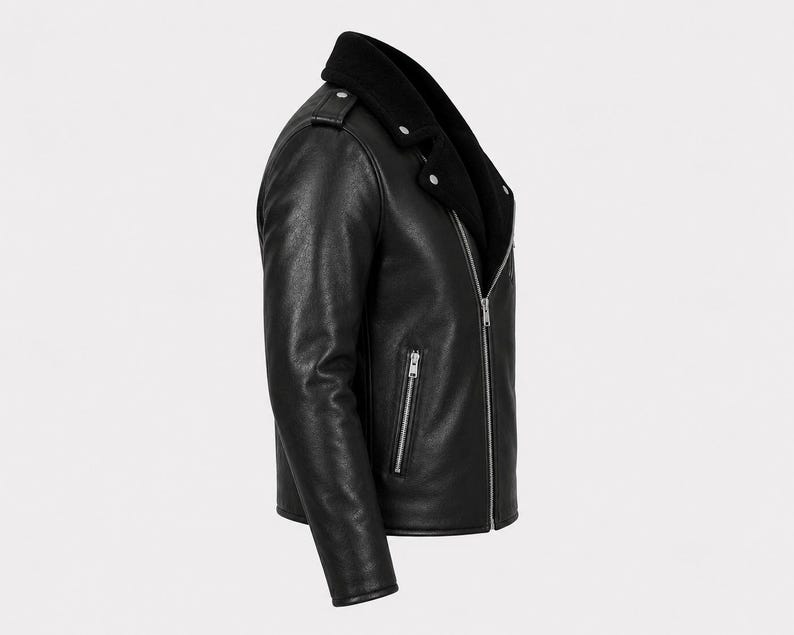 May include: A black leather motorcycle jacket featuring a wide collar, silver-toned metal zippers on the front and side pockets, shoulder epaulets with silver snaps, and long sleeves. The jacket is shown from a side profile view against a plain background.