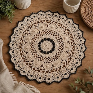 May include: A round, beige crochet doily featuring an intricate, openwork lace pattern with a central ring of small, dark brown textured bobbles and a scalloped outer edge trimmed in a contrasting dark brown thread throughout the perimeter.
