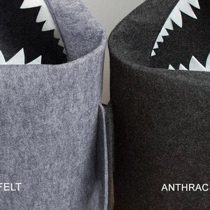 May include: Two felt storage bins, one grey and one dark grey, each with a shark-mouth design. The shark's mouth is created with white, jagged felt teeth. The grey bin is labeled "GREY FELT" and the dark grey bin is labeled "ANTHRACITE FELT".