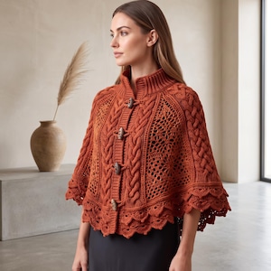 May include: A burnt orange knit poncho featuring a high collar, vertical cable knit patterns, and intricate openwork crochet detailing. The garment is secured down the front with four wooden toggle buttons and finished with a scalloped hemline.