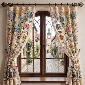 Puede incluir: Un par de cortinas de ganchillo de color crema con intrincadas aplicaciones florales en tonos azul, rosa, amarillo y lavanda. Las cortinas cuelgan de una barra marrón oscuro y se sujetan con alzapaños a juego con borlas decorativas.
