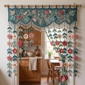 May include: A teal crochet valance hanging on a wooden rod, featuring intricate floral and bird motifs in shades of pink, cream, and green. The design includes dangling vertical strands adorned with crocheted flowers and leaves, finished with beads.