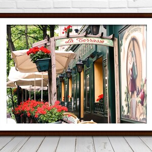 May include: A Parisian cafe with red flowers, green awnings, and a sign that reads "La Terrasse".