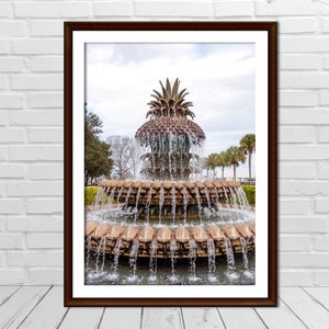 May include: A large pineapple fountain with cascading water, surrounded by lush greenery. The fountain is made of stone and has a traditional pineapple design.