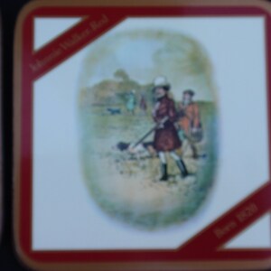 May include: A vintage style coaster with a red border and a white background. The coaster features a colorful illustration of people hunting in a field. The text "John Walker Red" and "Born 1820" are printed on the coaster.