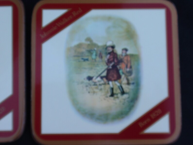 May include: A vintage style coaster with a red border and a white background. The coaster features a colorful illustration of people hunting in a field. The text "John Walker Red" and "Born 1820" are printed on the coaster.