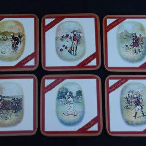 May include: Six square coasters with a red border and a white background. Each coaster features a different illustration of a man in a red coat and top hat participating in a different activity, such as fishing, playing croquet, and riding a horse. The text "Johnnie Walker Red" and "Born 1820" are printed on each coaster.