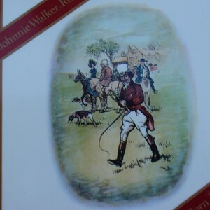 May include: A vintage illustration of a group of people on horseback riding through a field. The illustration is in a circular frame and features a man in a red jacket and white pants holding a whip. The text "Born 1820" is visible in the lower right corner of the image.