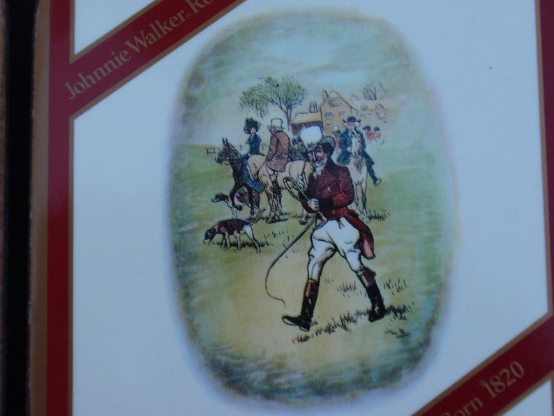 May include: A vintage illustration of a group of people on horseback riding through a field. The illustration is in a circular frame and features a man in a red jacket and white pants holding a whip. The text "Born 1820" is visible in the lower right corner of the image.