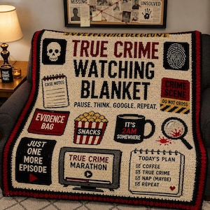 May include: A cream-colored crochet blanket featuring black and red true crime themed graphics and text including "TRUE CRIME WATCHING BLANKET," "PAUSE. THINK. GOOGLE. REPEAT.," "CASE NOTES," "EVIDENCE BAG," "SNACKS," "IT'S 2AM SOMEWHERE," and "TODAY'S PLAN."