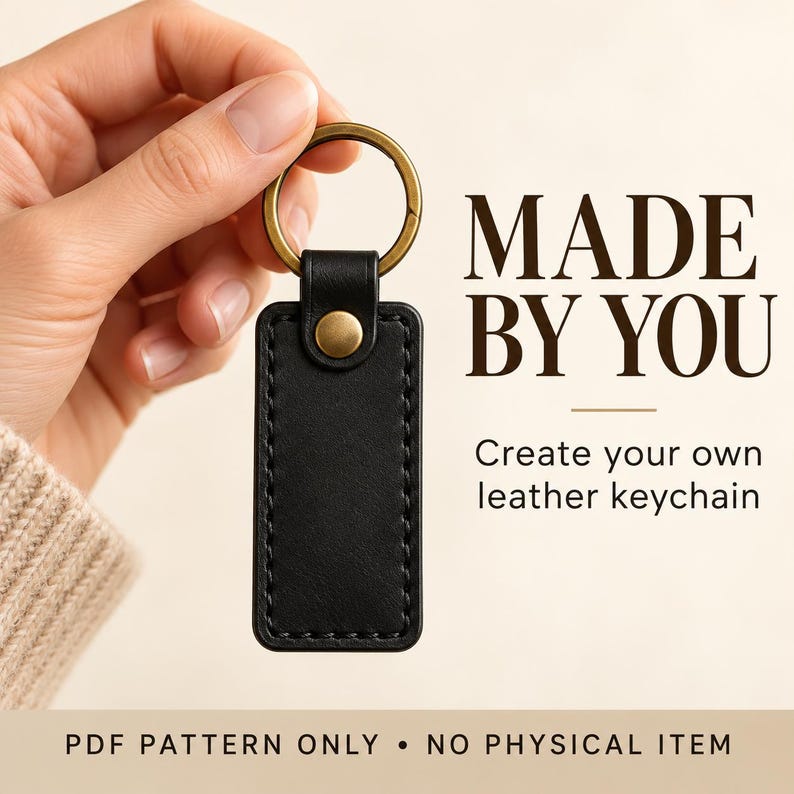 Black leather keychain with a large brass split ring and round brass snap against an ivory background, with “Classic Black & Brass” text.