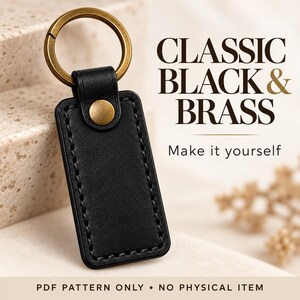 Close-up of black leather grain, perimeter stitching and brass snap on a rectangular keychain, labelled as a digital pattern only.