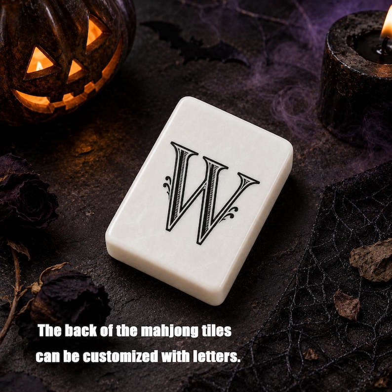 May include: A rectangular white mahjong tile featuring a black decorative letter W printed on its surface. The tile has a smooth, polished finish with rounded corners. The text on the image reads: The back of the mahjong tiles can be customized with letters.