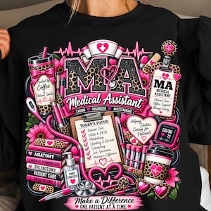 May include: A black sweatshirt featuring a graphic design for a Medical Assistant. The print includes a clipboard with a checklist, a stethoscope, medical supplies, coffee cups, and leopard print accents. Text includes "MA Medical Assistant" and "Make a Difference One Patient at a Time" along with various medical-themed phrases.