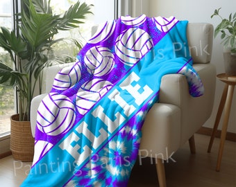 May include: A blue and purple tie-dye fleece blanket with white volleyball graphics and the word "VOLLEY" printed in white.