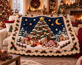 May include: A rectangular crochet blanket featuring a dark blue night sky with yellow stars and a crescent moon. The scene depicts a decorated Christmas tree, a standing deer, a sleeping teddy bear under a quilt, and a small house in the snow.