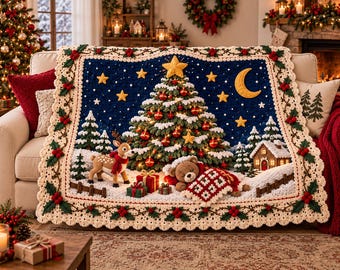 May include: A rectangular crochet blanket featuring a dark blue night sky with yellow stars and a crescent moon. The scene depicts a decorated Christmas tree, a reindeer, a sleeping teddy bear with a red and white quilt, and a small house.