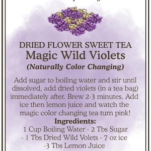 May include: A label for "Magic Wild Violets" dried flower sweet tea. The label features text and a purple floral illustration. The tea is naturally color-changing. Ingredients include sugar, dried violets, and lemon juice.