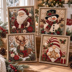 May include: Four square framed wall art pieces featuring textured Christmas scenes. One shows Santa Claus, one a snowman, one a reindeer, and one a gnome holding a star cookie. Each piece is decorated with pine branches, berries, and snowflakes.