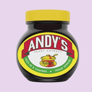 May include: A dark brown glass jar with a yellow screw-top lid. The label features the text ANDY'S YEAST EXTRACT in white on a red banner, with the words RICH IN B VITAMINS and VEGAN SPREAD on a green background, and a small pot illustration.