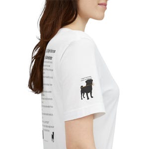 May include: A white t-shirt featuring black text on the side that reads Top 10 Signs You're an LMS Administrator, followed by a list of points. On the sleeve, there is a black silhouette of a dog holding a trident with the text Trident eLearning Center and Services.