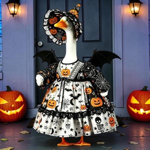 May include: A white goose figurine dressed in a black and white Halloween-themed outfit featuring orange pumpkins, spiderwebs, stars, and skulls. The goose wears a matching pointed hat and black bat wings, standing upright with orange webbed feet.