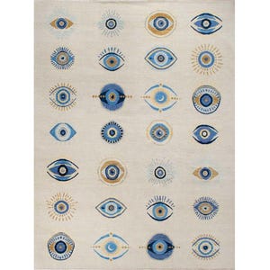 May include: A rectangular area rug with a cream-colored background featuring a repeating grid pattern of various eye motifs in shades of blue, gold, and white. The design includes stylized circular and almond-shaped eye icons with rays.