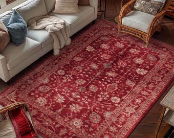 May include: A large rectangular area rug featuring a deep red background with an intricate floral and vine pattern in shades of cream, light pink, and muted blue, finished with a detailed decorative border along all four edges.
