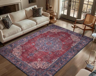 May include: A rectangular area rug featuring a deep red and blue color palette with a central medallion design and intricate floral border patterns. The rug displays a distressed texture and covers a large portion of the wooden floor space.