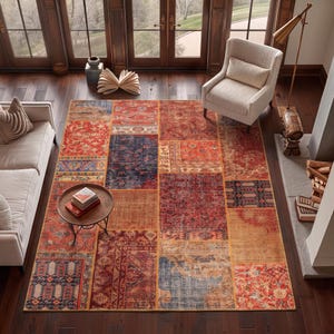 May include: A rectangular area rug featuring a patchwork design composed of various sections with intricate patterns in shades of red, orange, blue, and tan. The rug displays a mix of floral, geometric, and distressed motifs across its surface.