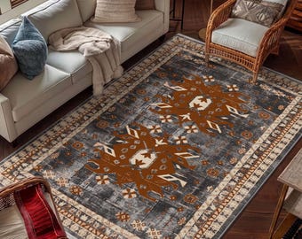 May include: A rectangular area rug featuring a dark gray distressed background with two large, symmetrical burnt orange geometric medallions and a wide border with intricate cream and brown patterns, finished with short white fringe.