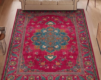 May include: A rectangular area rug featuring a vibrant magenta background with a central teal medallion. The design includes intricate floral motifs, stylized birds, and a geometric Greek key border in shades of green, orange, and cream.