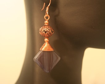 Copper wire wrapped earrings with deep purple frosted beads.