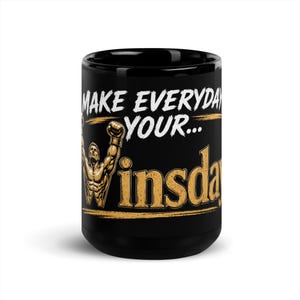May include: A black ceramic mug featuring the white text "MAKE EVERYDAY YOUR..." above a large, gold-colored graphic of a muscular figure with arms raised in victory, forming the letter "W" in the word "winsday" written in gold lettering.