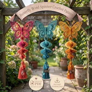 May include: Three hanging crochet wind spinners shaped like butterflies in pink, teal, and orange. Each features intricate wing patterns, a spiral tail, and a bottom tassel with beads and charms. A banner at the top reads Butterfly Wind Spinner Crochet Pattern.