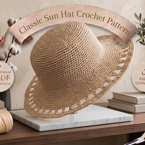 May include: A tan crochet sun hat with a wide brim featuring a decorative openwork border. A banner at the top displays the text Classic Sun Hat Crochet Pattern. Circular icons on the sides indicate Premium PDF Instant Access and Instant Download.