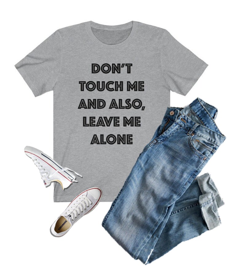 May include: A gray t-shirt with the text "DON'T TOUCH ME AND ALSO, LEAVE ME ALONE" printed in black.