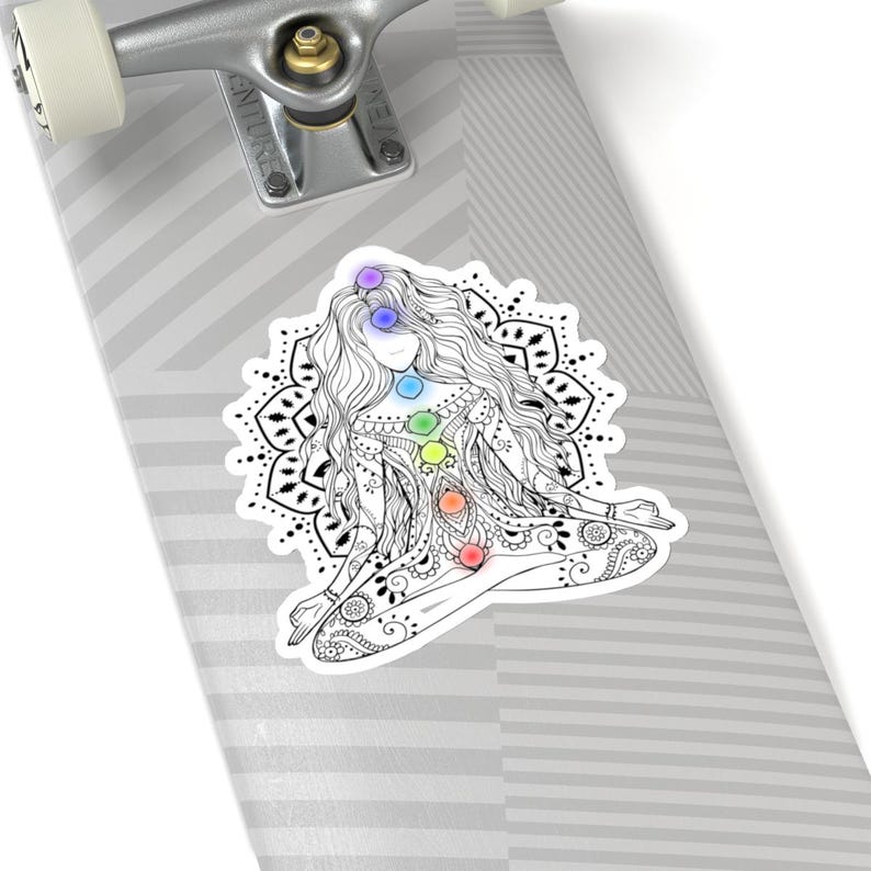May include: A black and white illustration of a woman sitting in a yoga pose with a mandala behind her. The woman has seven chakras represented by colored circles along her body.