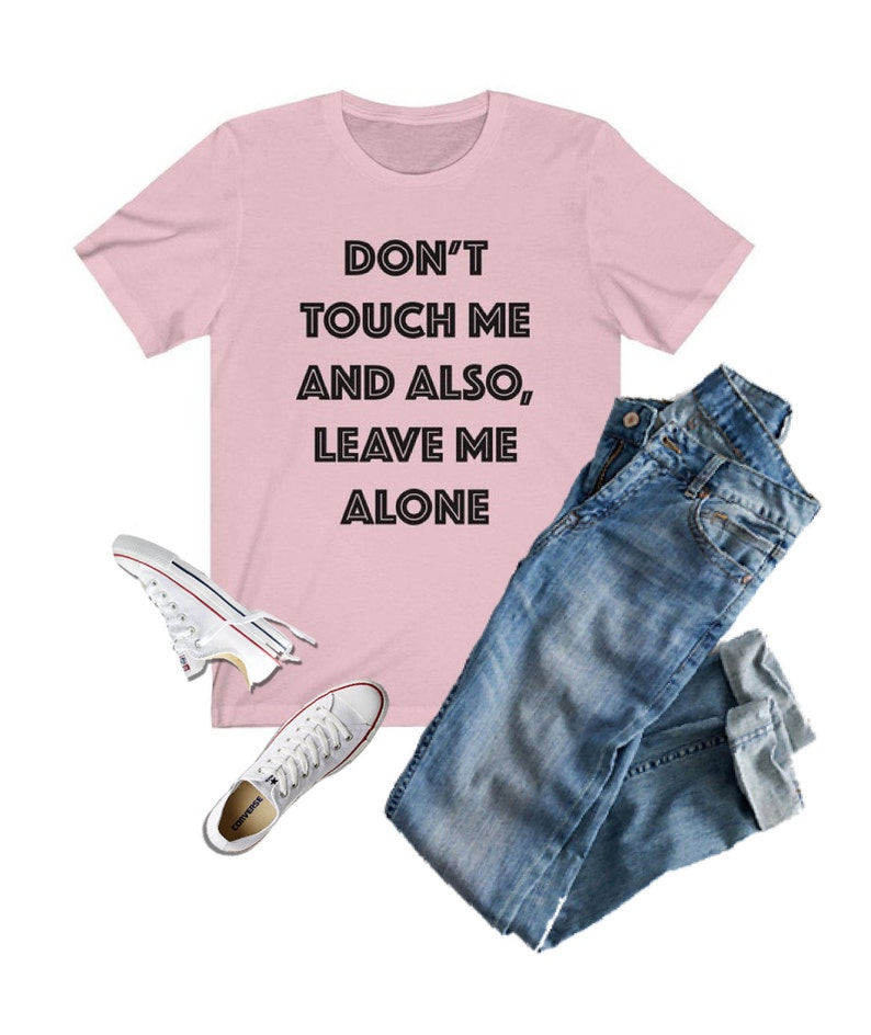 May include: Pink t-shirt with the text "Don't touch me and also, leave me alone" in black.