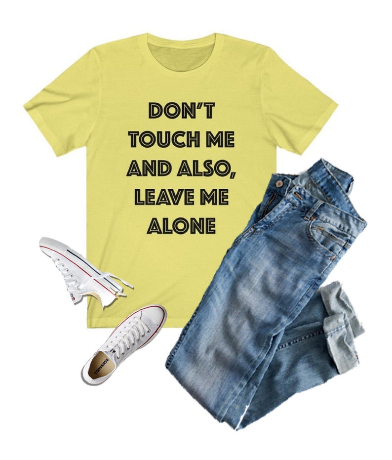 May include: A yellow t-shirt with the text "DON'T TOUCH ME AND ALSO, LEAVE ME ALONE" printed in black.