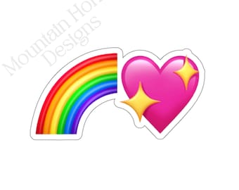 May include: A sticker featuring a rainbow and a pink heart with two yellow sparkles. The rainbow has red, orange, yellow, green, blue, and purple stripes. The text "Mountain Honey Designs" is in the upper left corner.