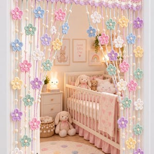 May include: A handmade crochet door curtain featuring a scalloped top border and vertical strands adorned with pastel-coloured flowers in shades of pink, blue, yellow, purple, and white, interspersed with small wooden beads throughout the design.